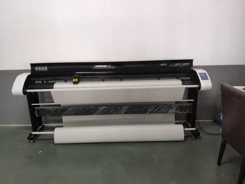 Computerized cutting plotter loaded with a fabric roll on the production floor