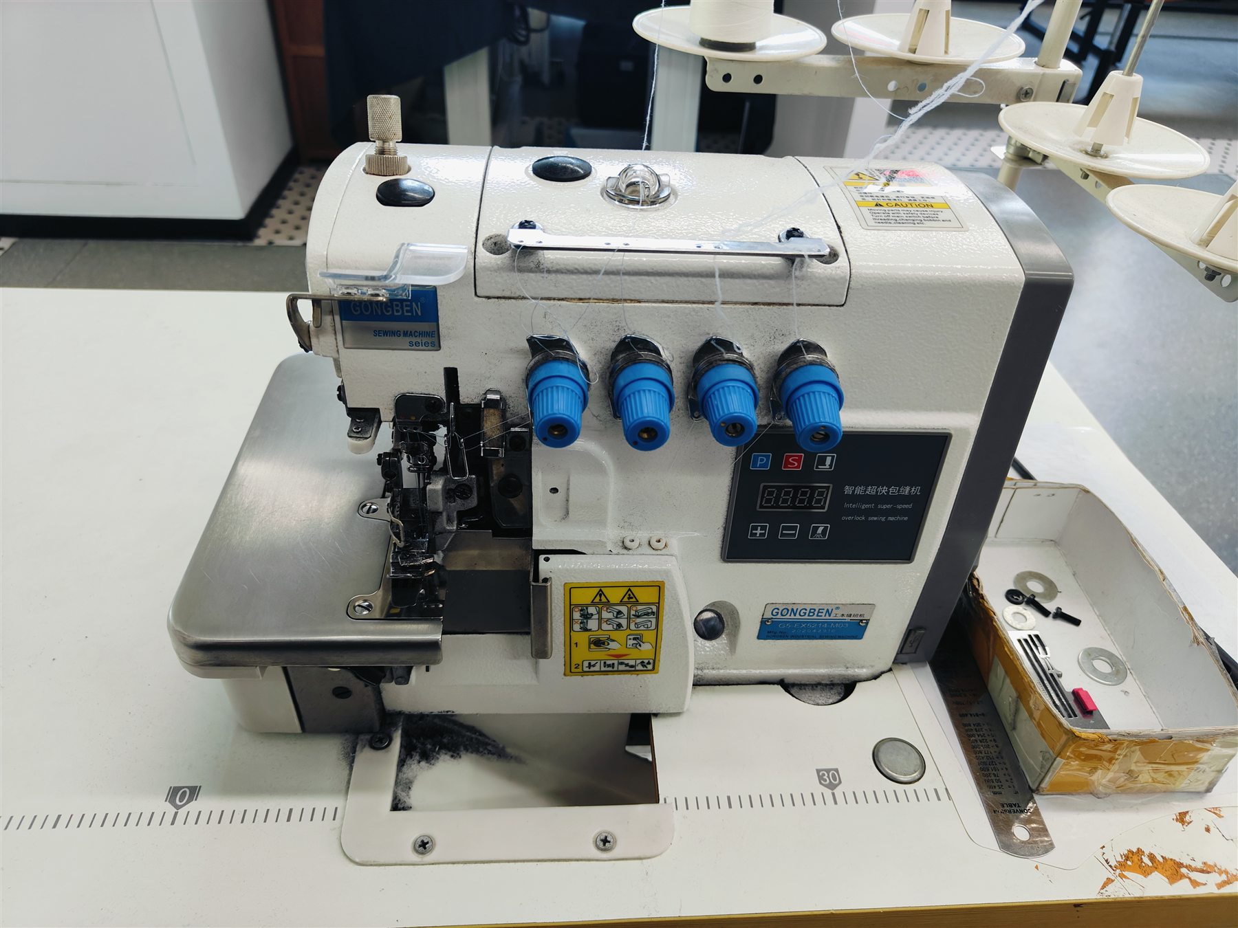 Close view of a multi-thread industrial sewing machine