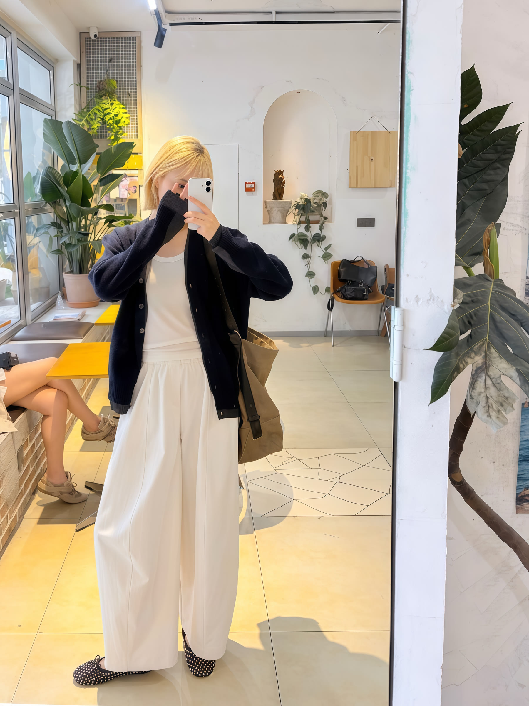 White wide-leg trousers shown in a mirror try-on